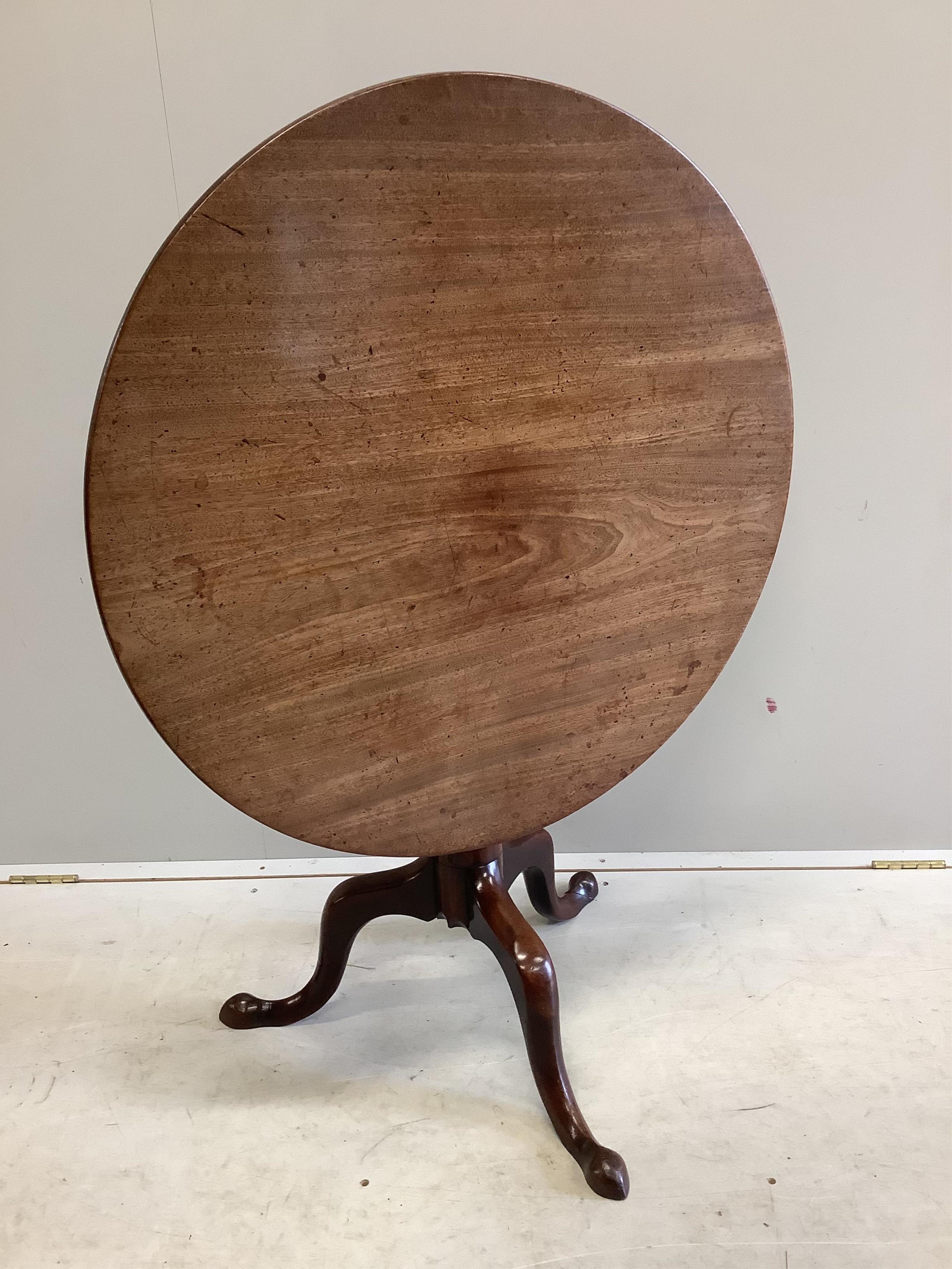 A George III circular mahogany tilt top tripod tea table, diameter 79cm, height 70cm. Condition - fair to good